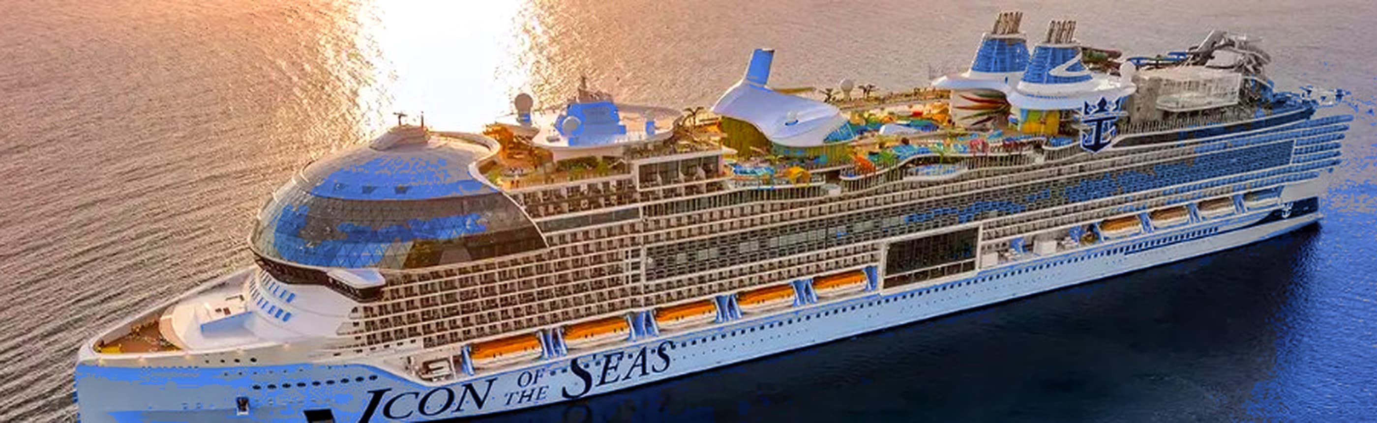Icon of the Seas on clear blue water, with sunlight shining across the surface and the ship name visible on the hull