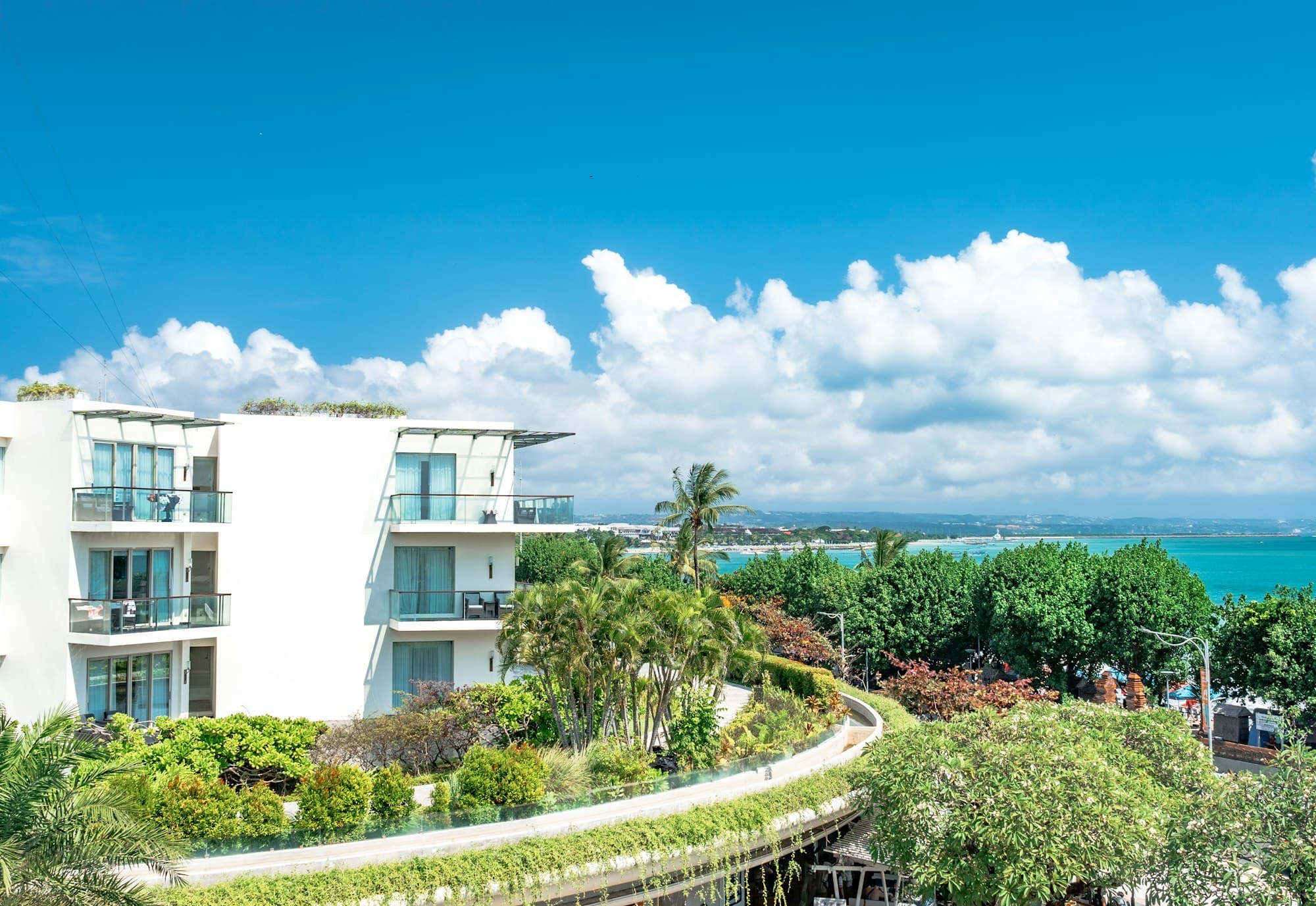 White modern hotel above a turquoise coastline